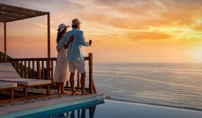 Couple enjoying a golden sunset by the sea on a relaxing beach in Maldives