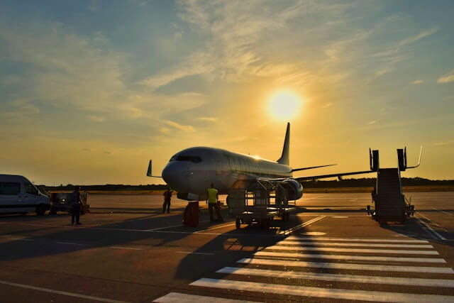 Flight parked on runway at sunset