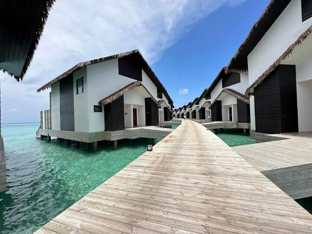 Wooden walkway leading to water villas